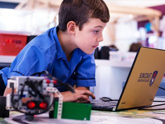 Robot and Laptop with Suncoast Upper Primary Student