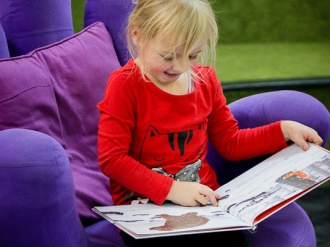 Suncoast LIttle Leaner reading book in funky chair